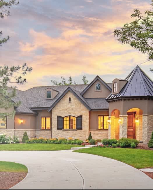 A large house with a conical roof and a driveway leading to it