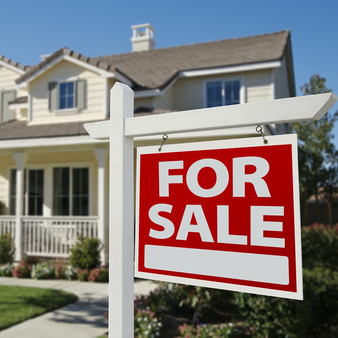Home with For Sale sign in front yard