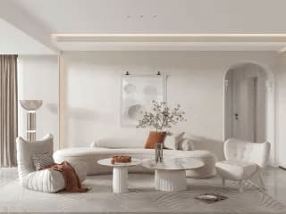 A living room with a beige couch, two white chairs, and a coffee table