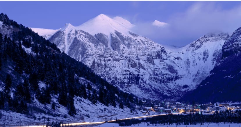 Snow-covered mountains at dusk in Telluride, Colorado.