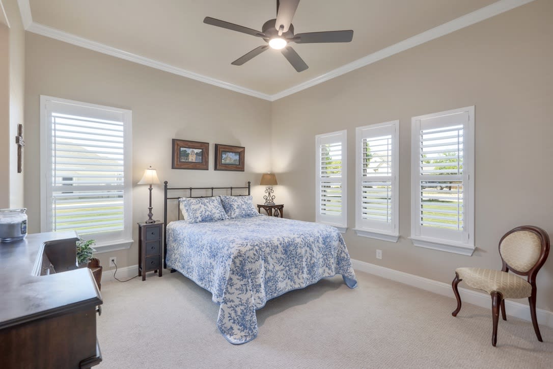 Secondary bedroom #3 Timeless charm of plantation shutters adorning each window creating an ambiance of elegance and privacy.