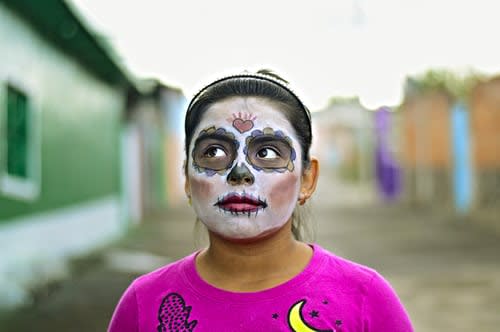 San Diego girl wearing traditional face paint for Dia de Los Muertos