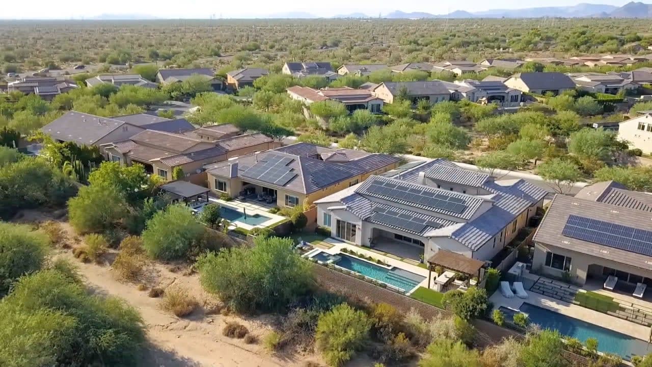 Aerial view of desert homes: Tranquil desert landscape showcasing luxury homes and houses.