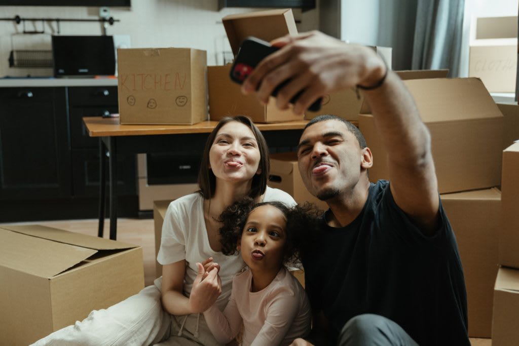 Child smiling while helping pack during a move