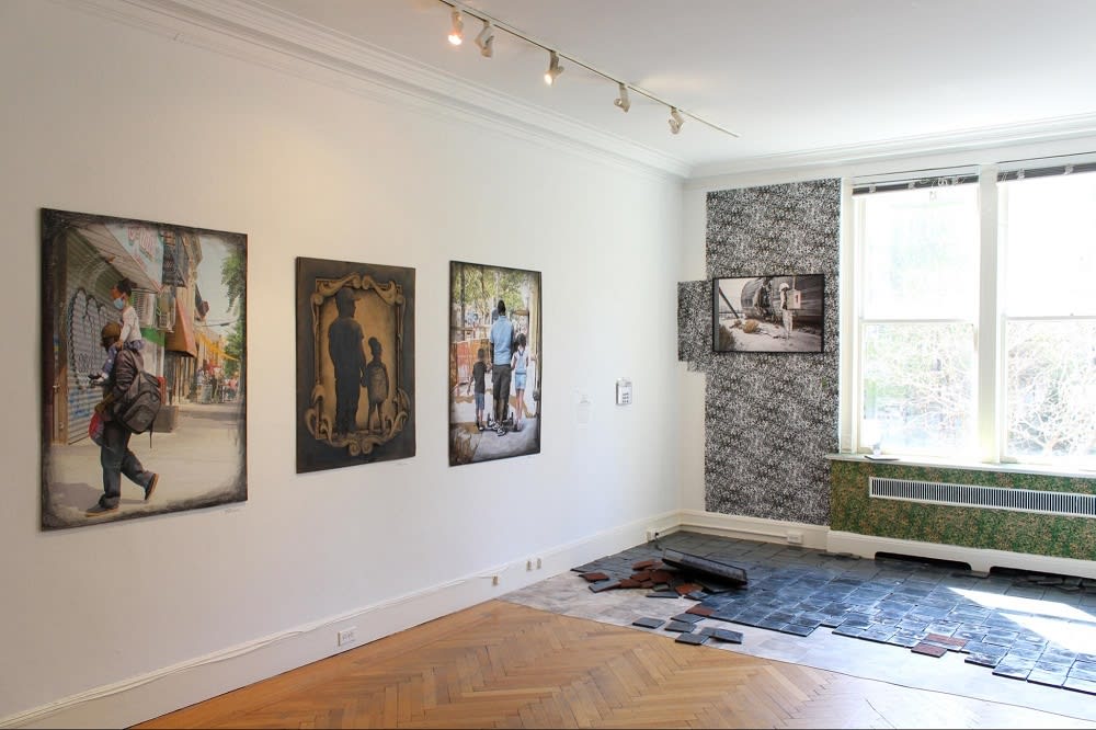 tiled floor in progress near a window with paintings on the wall at The Center for Emerging Visual Artists