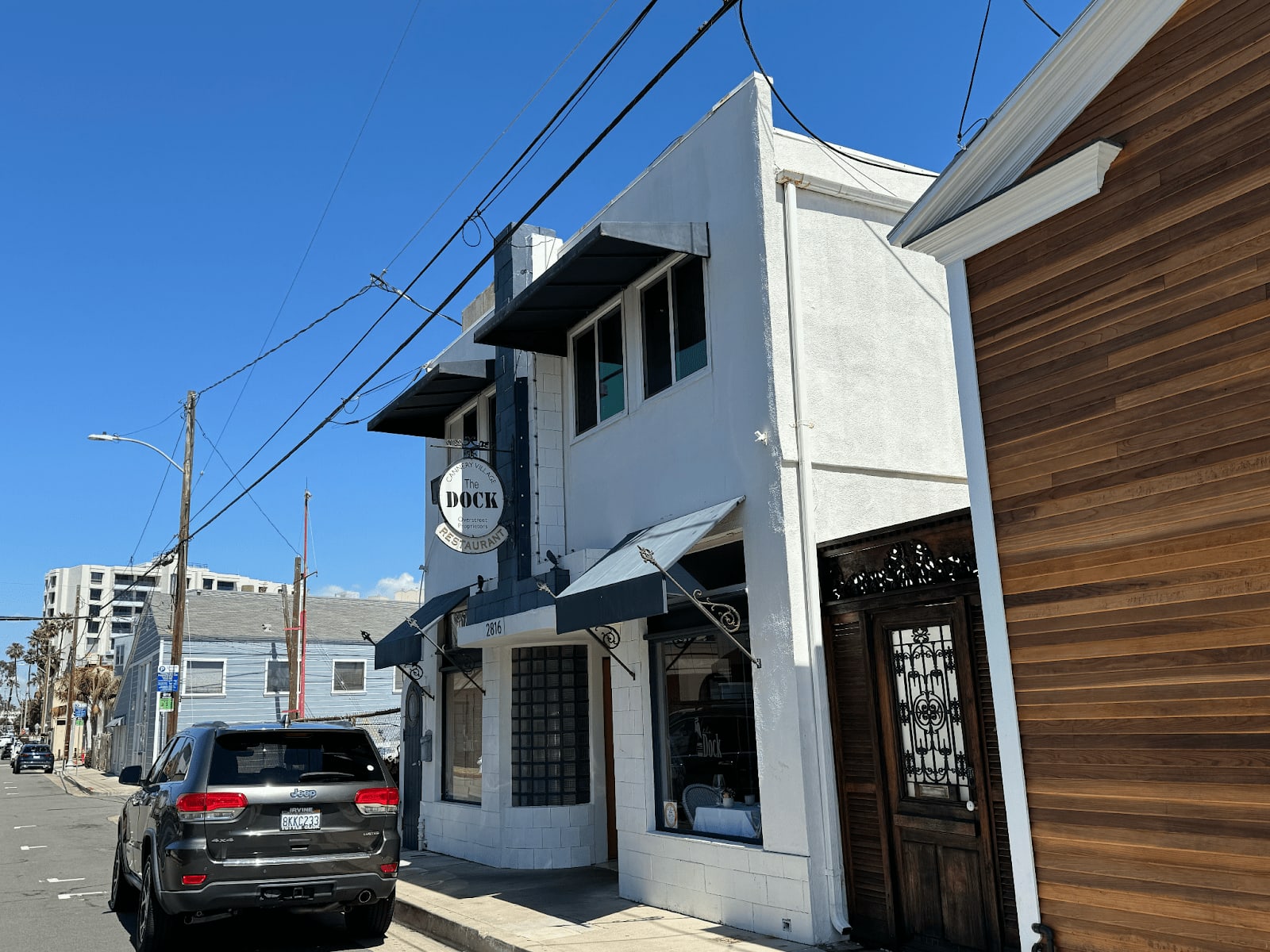 The Dock restaurant entrance on a quiet street in Newport Beach, California.
