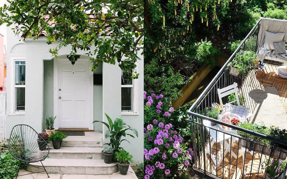 White home entrance with potted plants beside a garden deck with lounge seating and purple flowers.