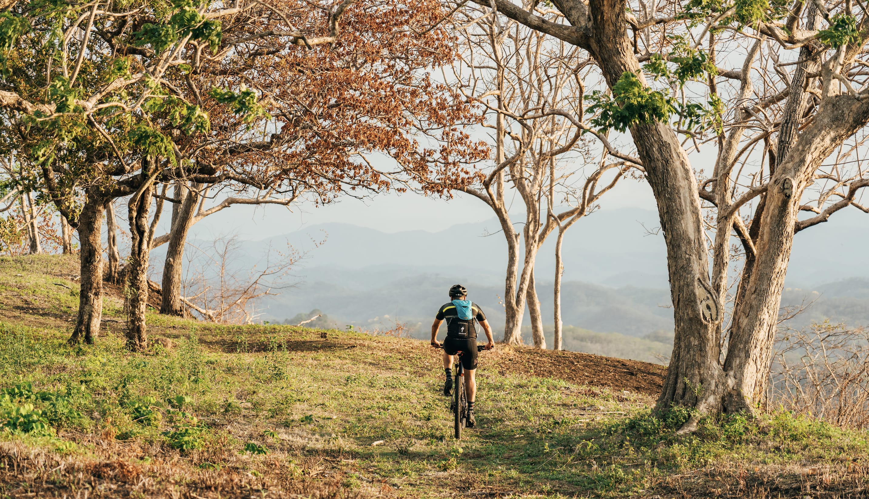 man riding mountain bike over the sustainable trails of guanacaste costa rica