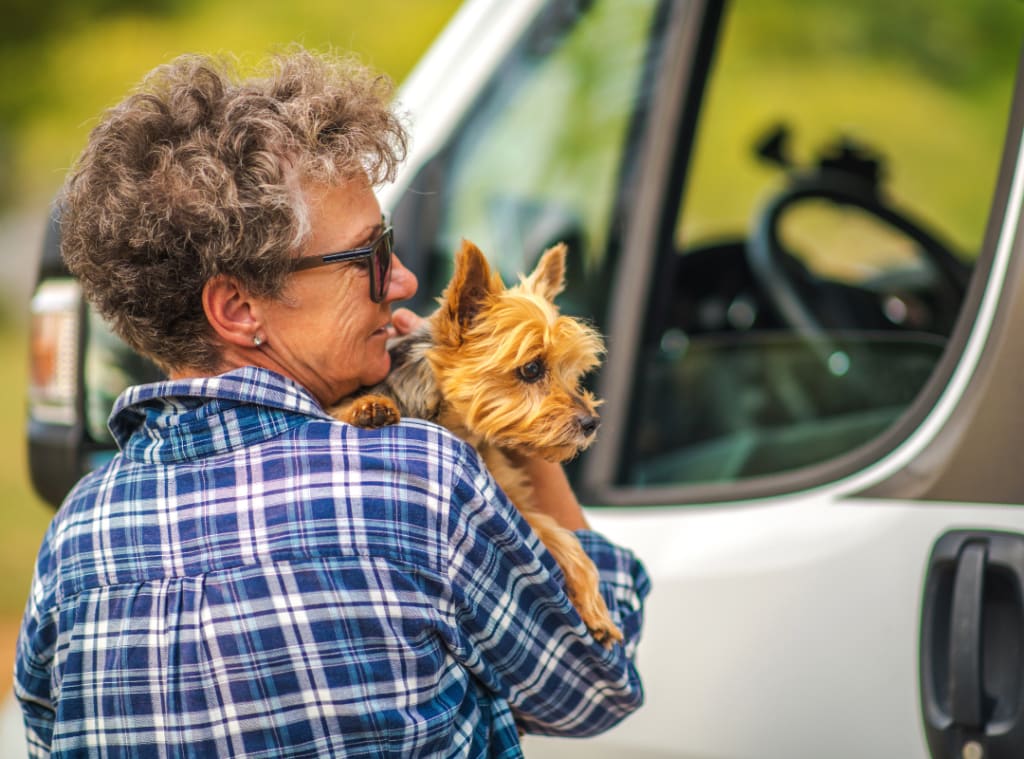 a senior holding her dog