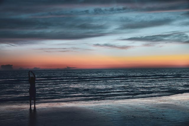 Silhouette of a woman on a beach at sunset