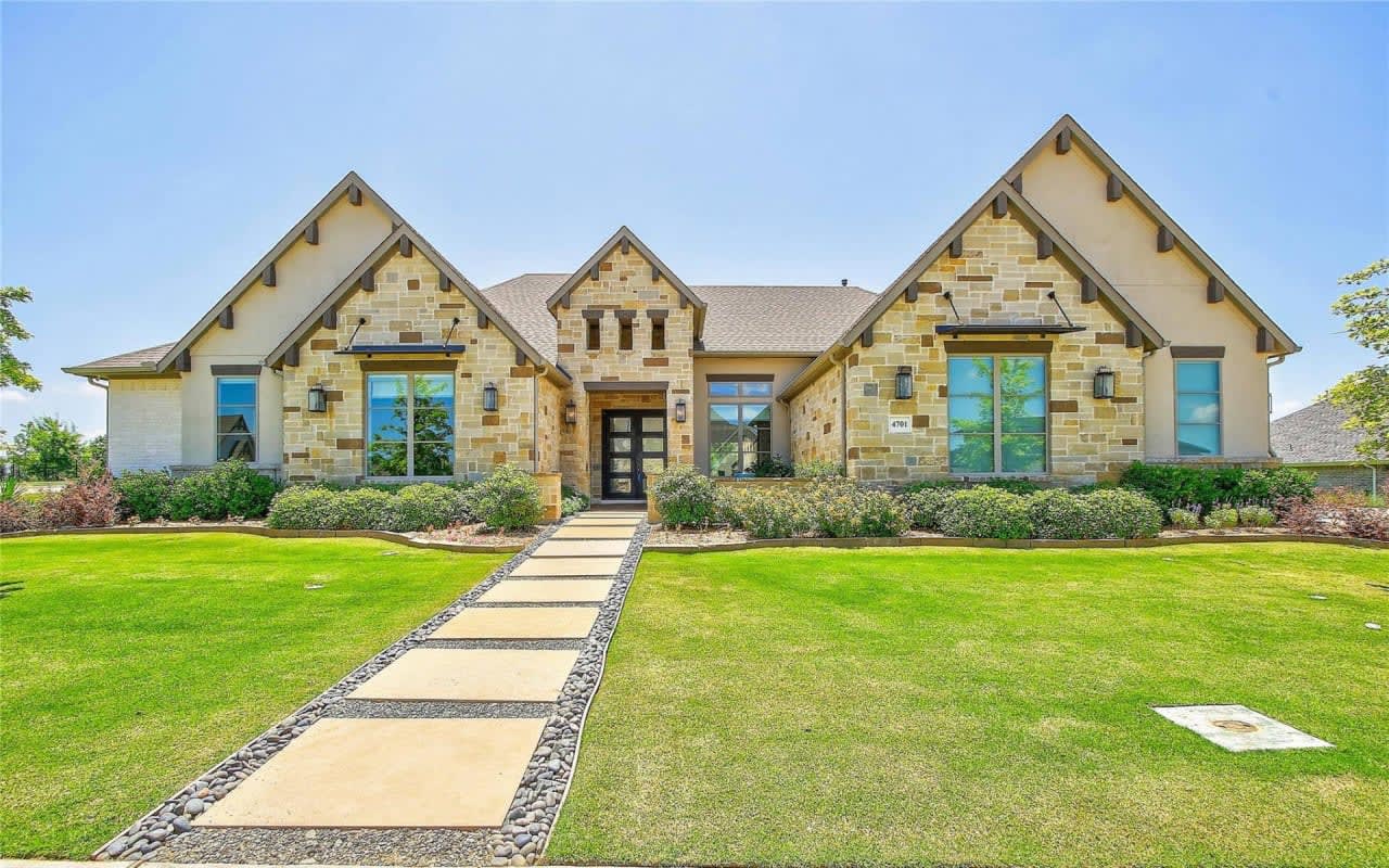 An inviting two-story residence with a beautifully landscaped backyard and a versatile patio for entertaining and enjoying the outdoors in Friendswood, Texas.