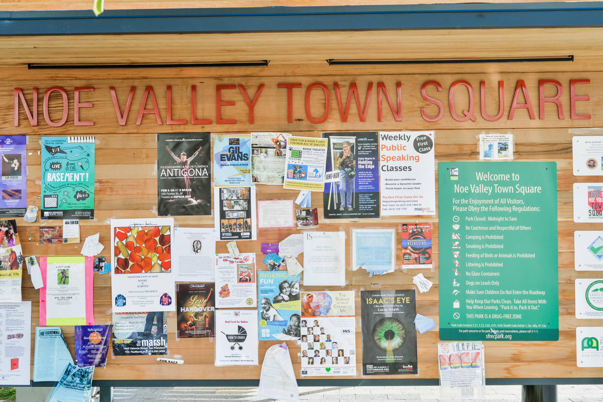 Noe Valley Town Square bulletin board with flyers posted to it