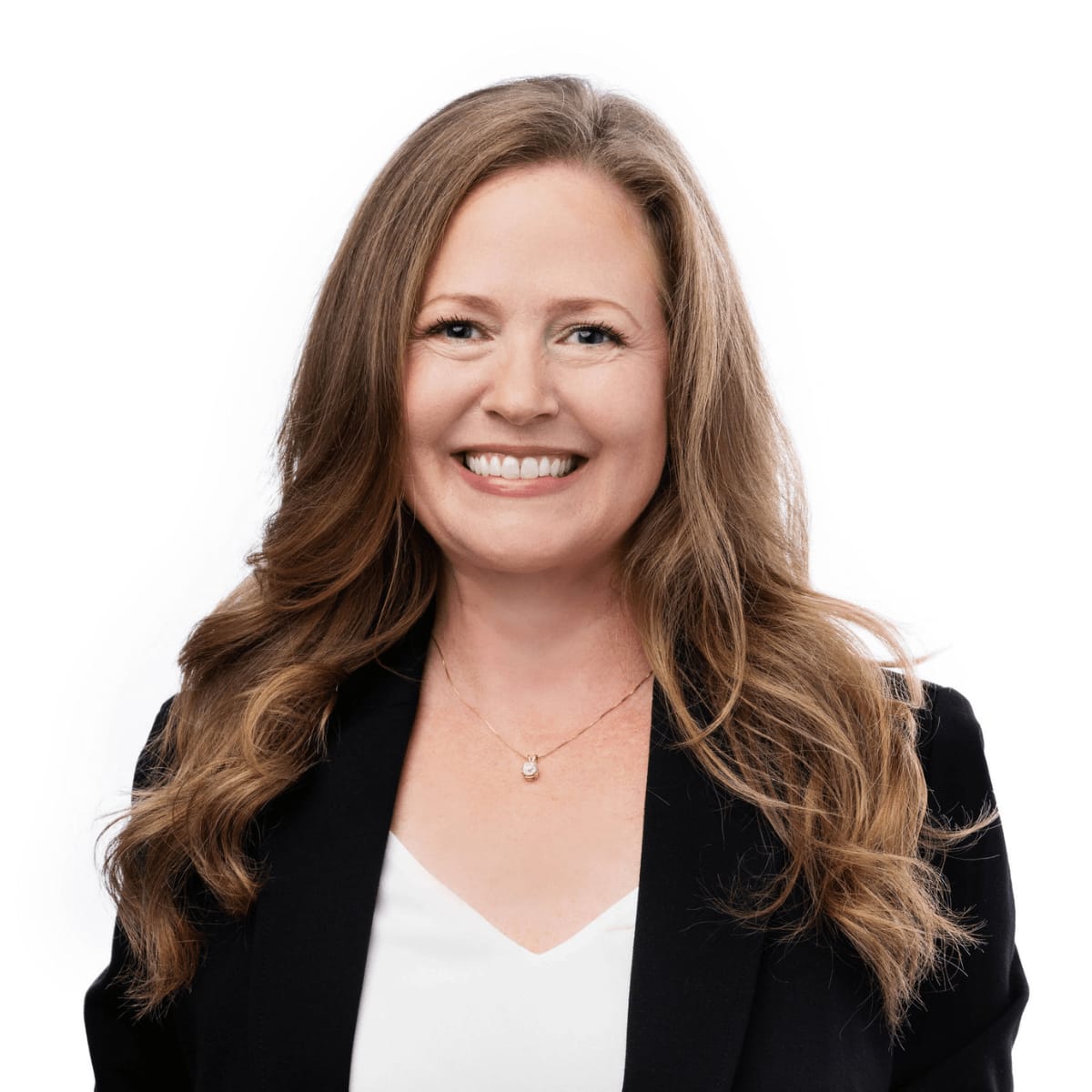 A professional headshot of Sarah Goldie McKinzie wearing a black blazer over a white blouse. 