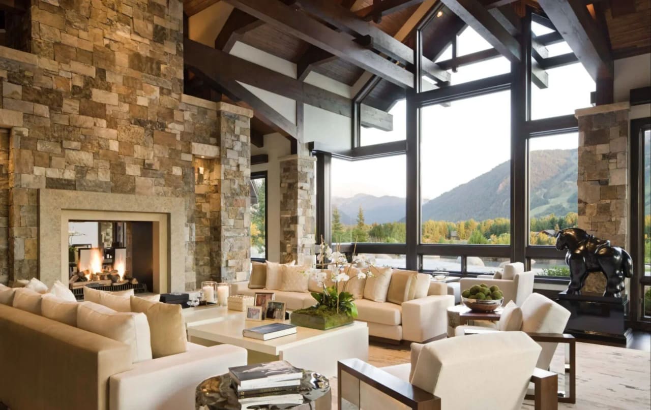 Living room in Durango, Colorado, with a fireplace and a stunning view of the San Juan Mountains. 