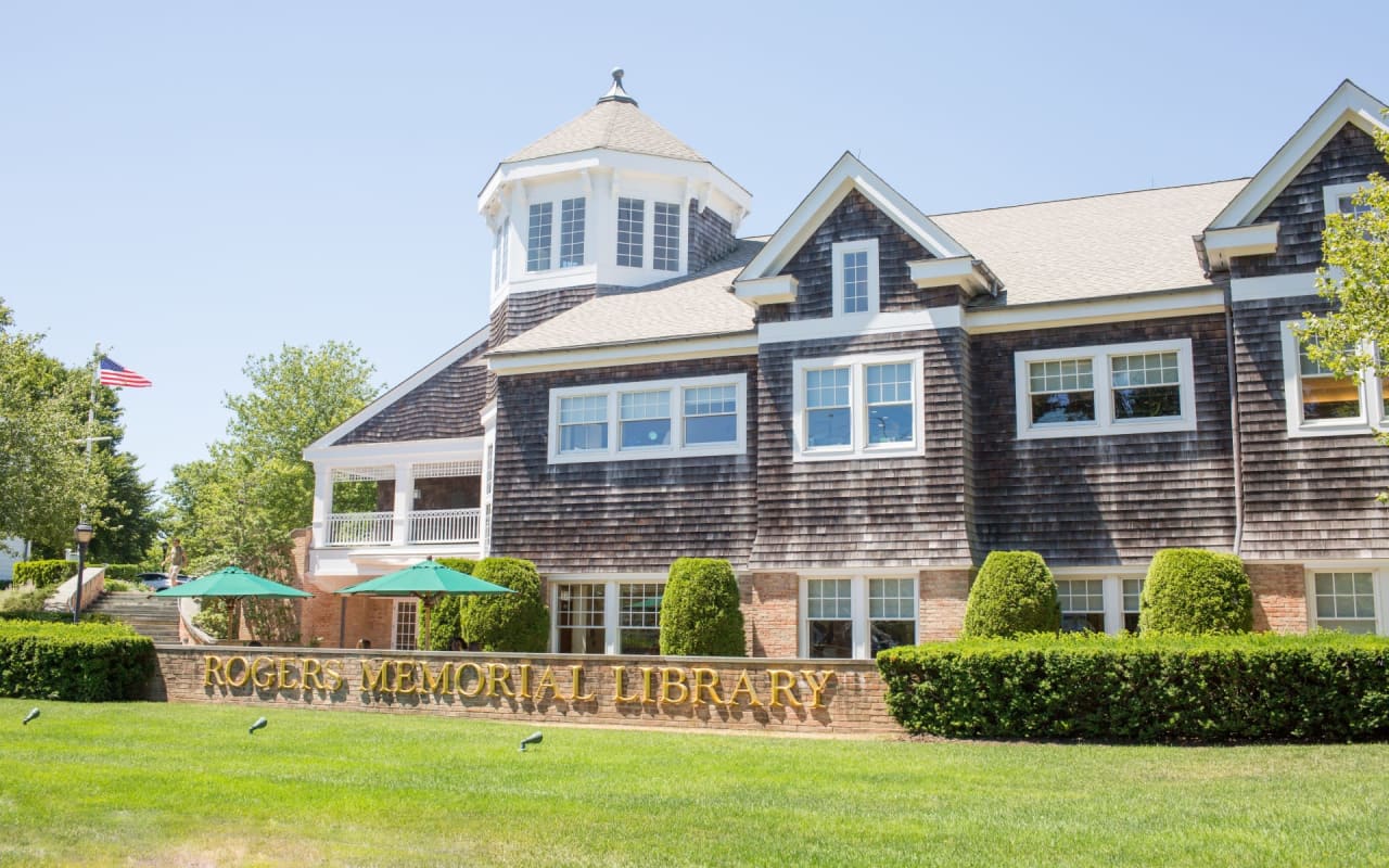 A large building with a sign that says "Rogers Memorial Library"