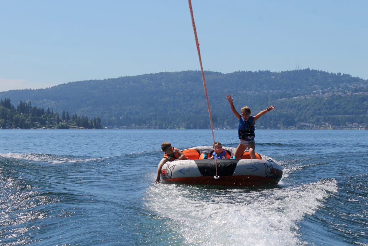 kids riding on a inflatable watersports