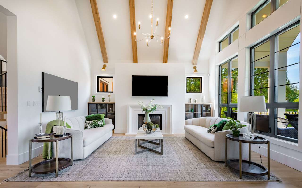 A living room with a couch facing a fireplace