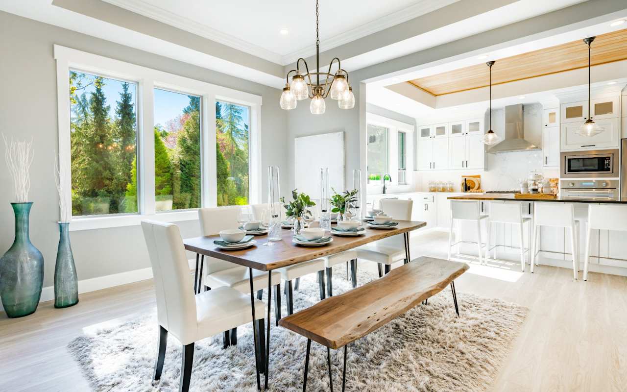 A dining room with a rectangular wooden table