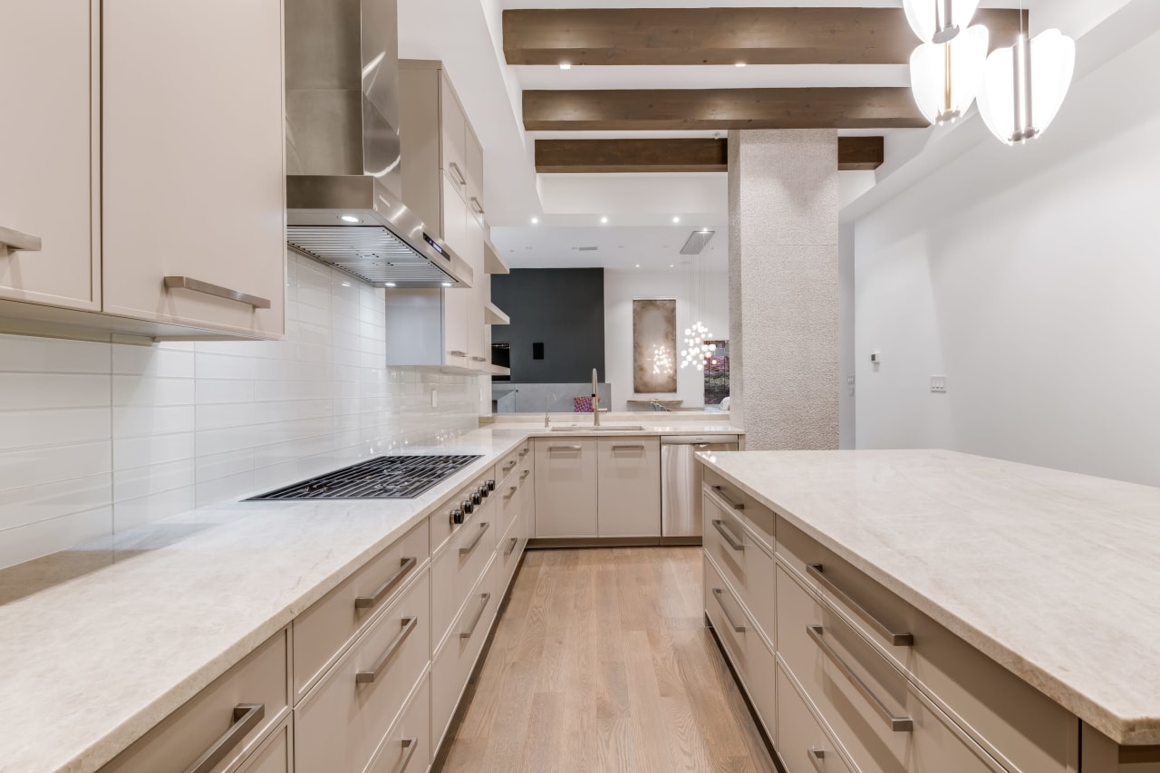 Sleek, contemporary kitchen with stylish grey cabinets and pristine white countertops, creating a harmonious ambiance.