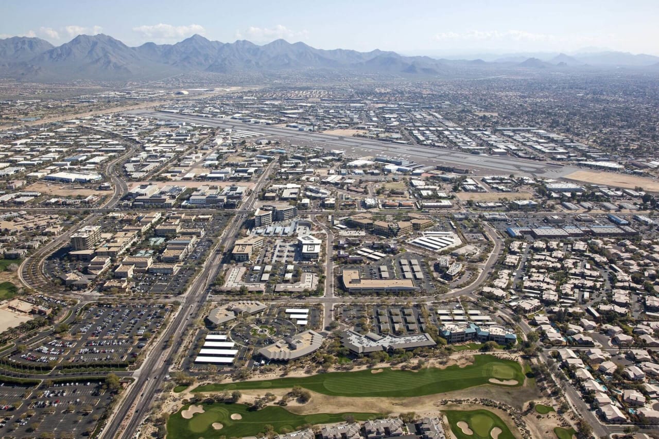 Serene Scottsdale Airpark at dusk, mountains in the distance, and golden light paints the sky