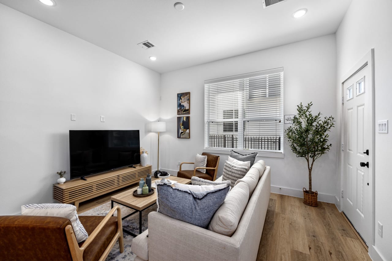 model living room with a large television 