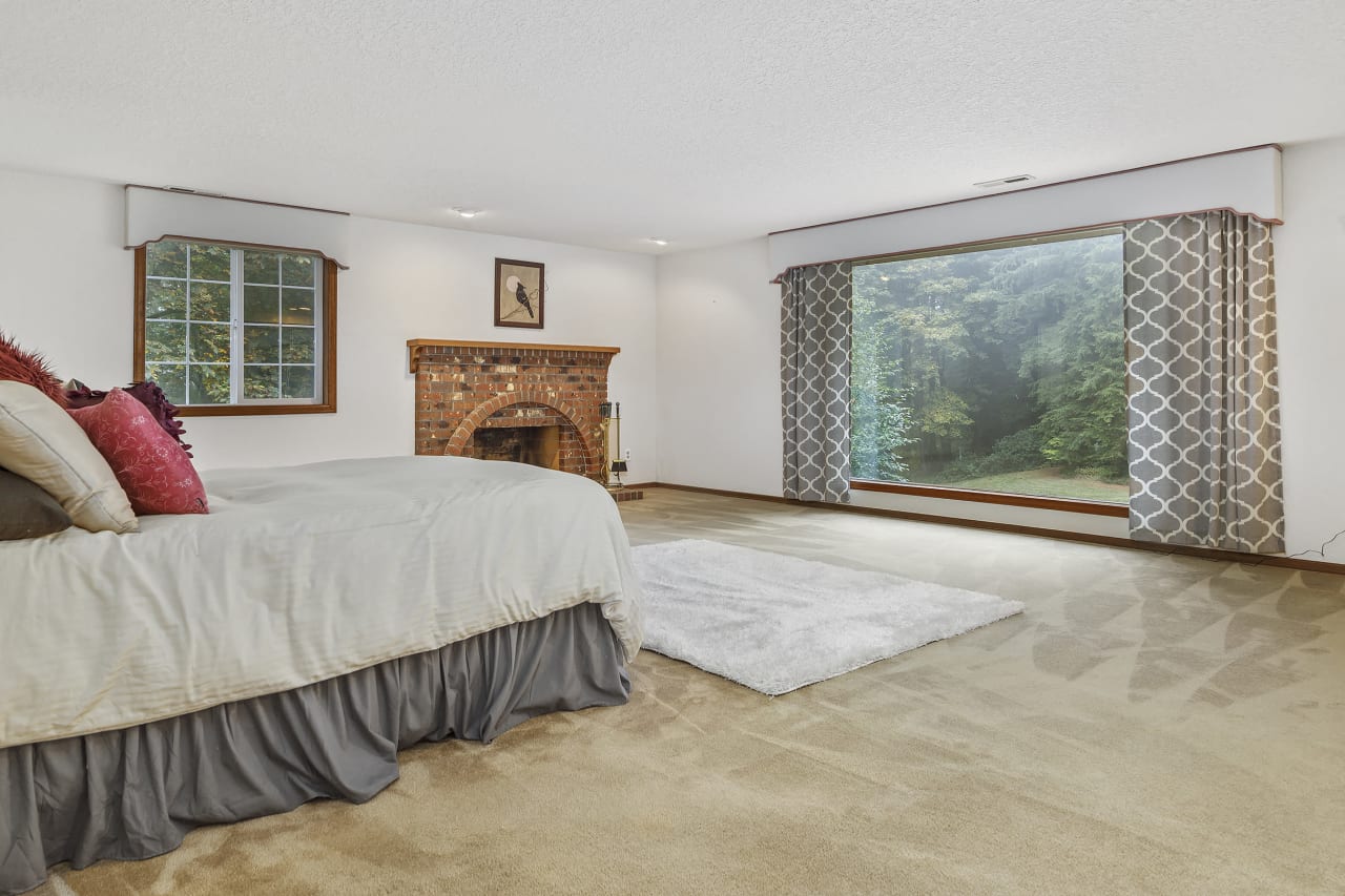 Imagine waking up to a stunning view of the very large private yard through the expansive picture window in the primary bedroom. It's a breathtaking way to start your day.