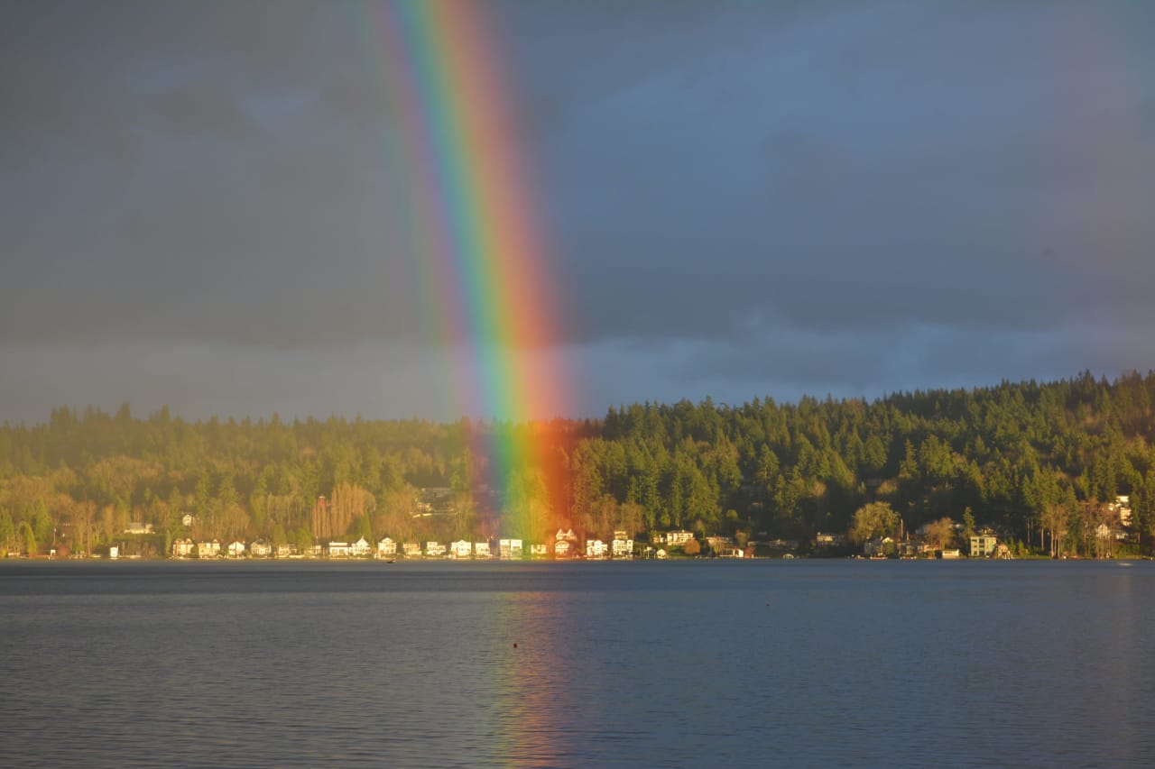 A rainbow arcing over a calm lake