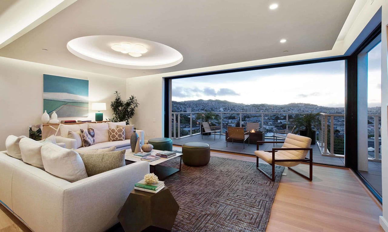 Exquisite luxury interior of a Bernal Heights home for sale featuring expansive windows offering stunning vistas of Bernal Hill and surrounding natural beauty.