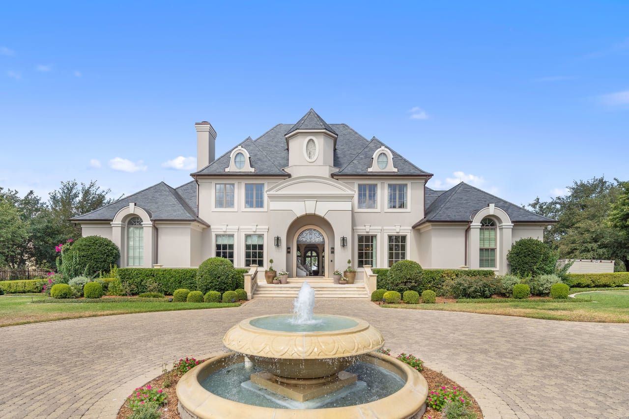 Presenting a grand entrance that exudes elegance: a sweeping circular driveway leads you to the majestic fountain centerpiece. The residence boasts a fresh slate roof, accentuated by gleaming copper gutters, embodying timeless sophistication.