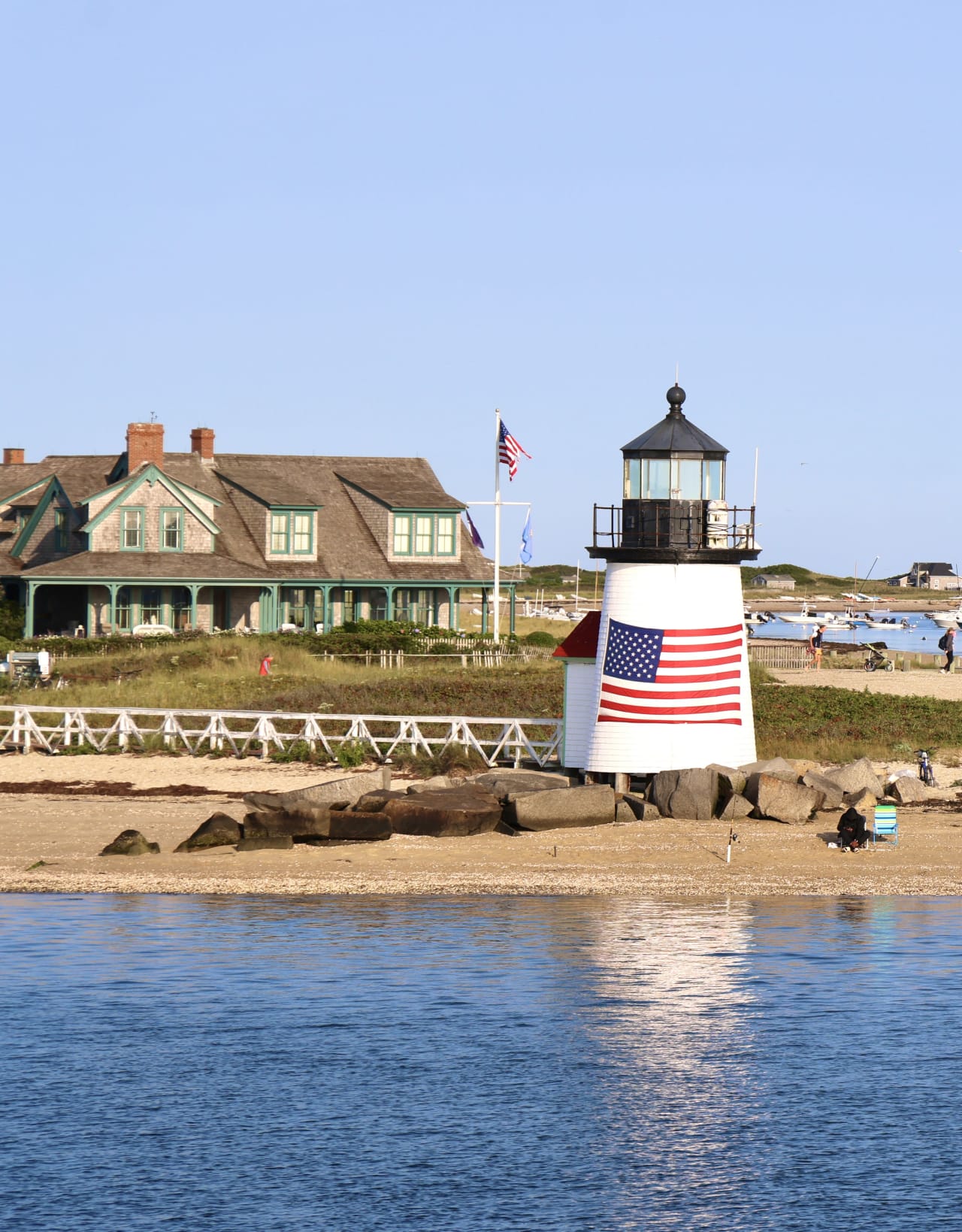 Brant Point Lighthouse in Nantucket with an American flag on its side.