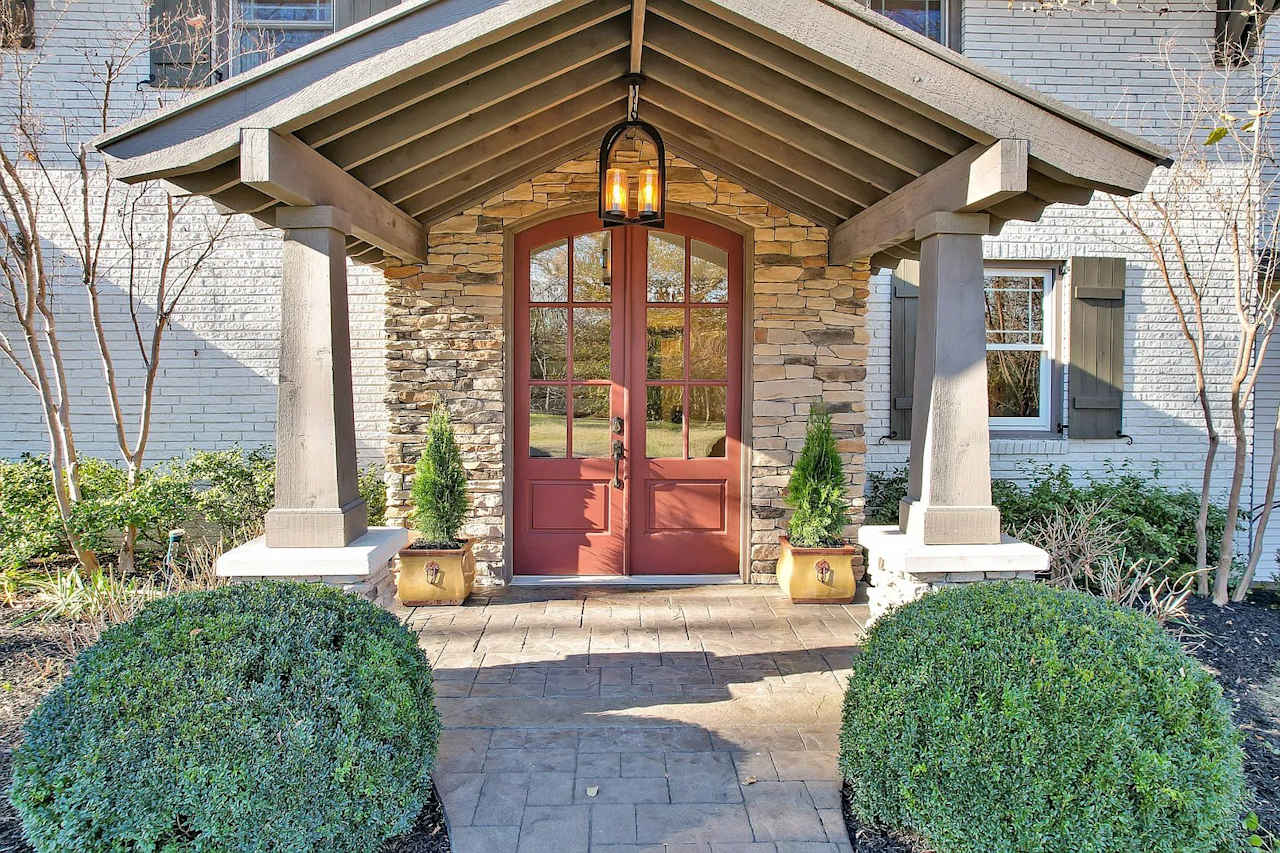 A house with a covered porch over the front door.