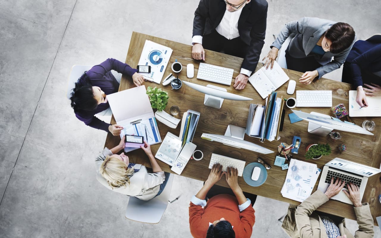 an aerial view of employees on a desk working