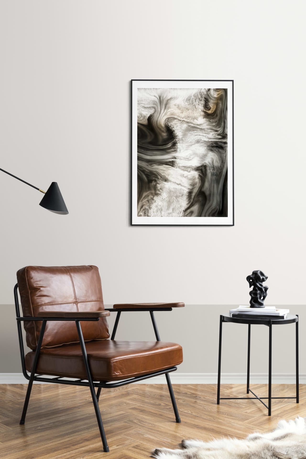 A cozy room with a brown leather chair, a wooden table, and an abstract painting