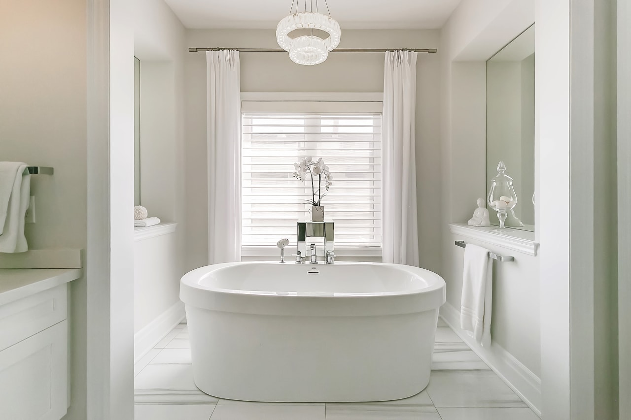 A modern bathroom with a white freestanding bathtub.