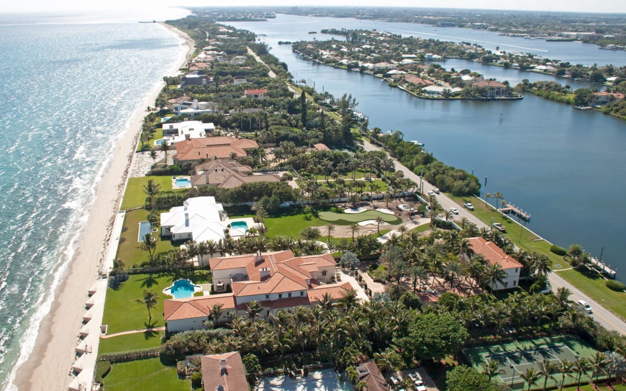 aerial photo of luxury waterfront houses with pools in Manalapan