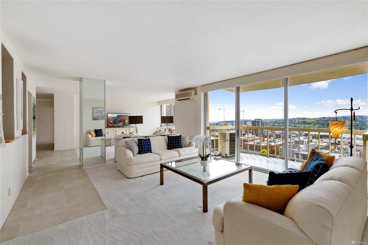 Bright and airy luxury condo living room with plush seating and expansive views.