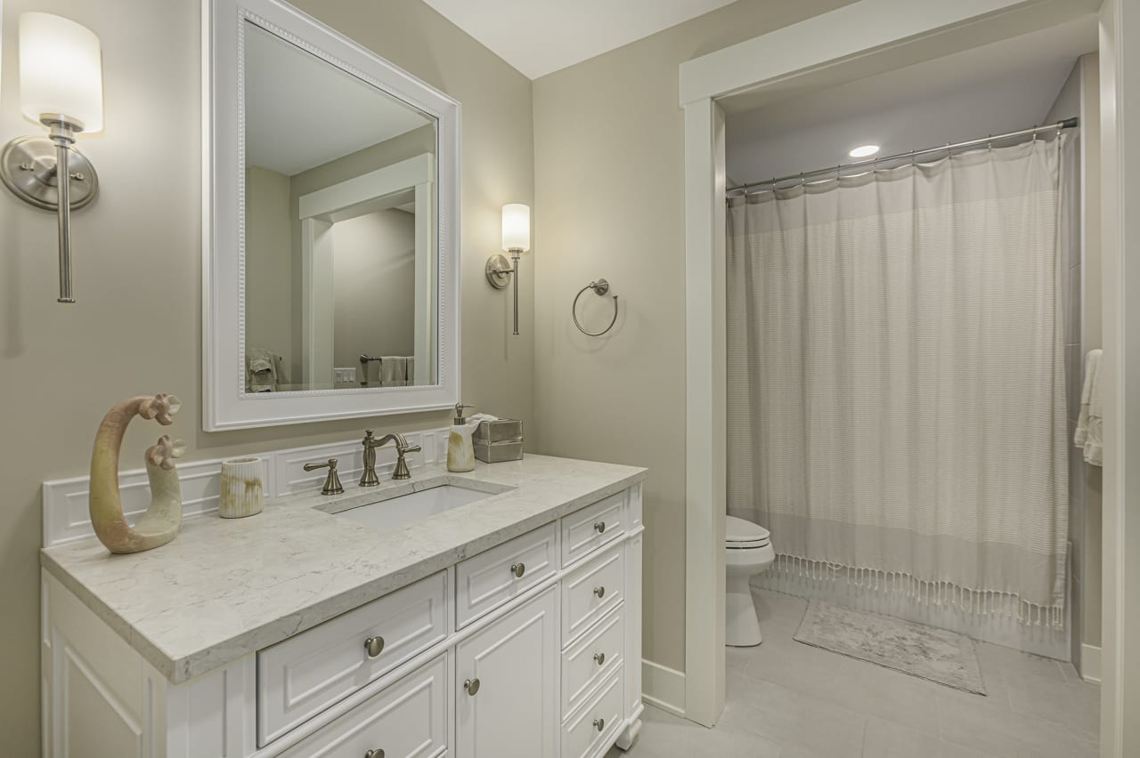 modern bathroom with sink and mirror and a bath