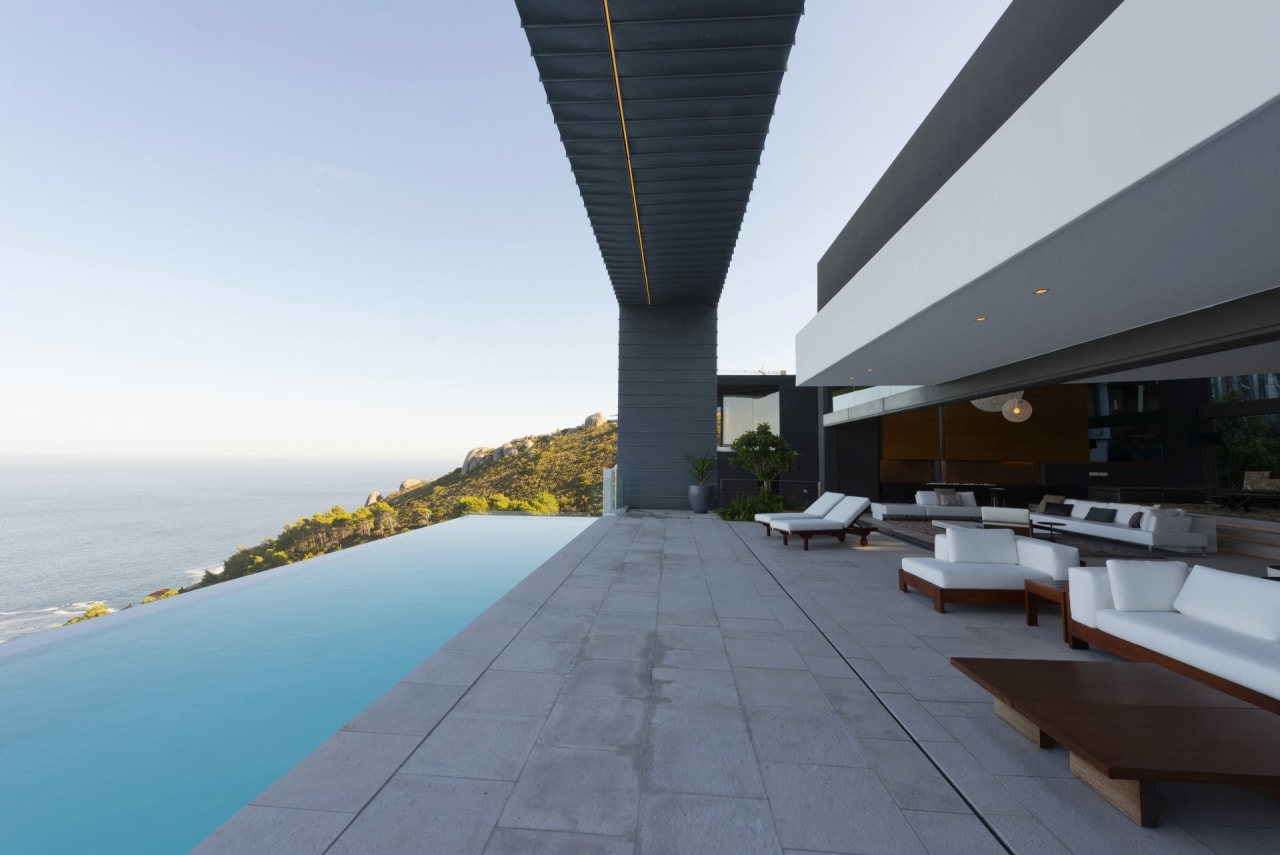A modern house with a swimming pool and a view of the ocean