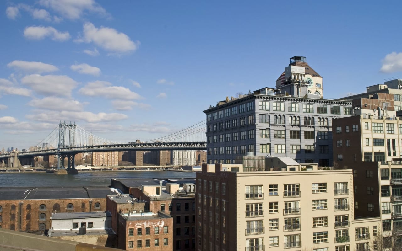 New York City skyline with Manhattan Bridge in foreground.