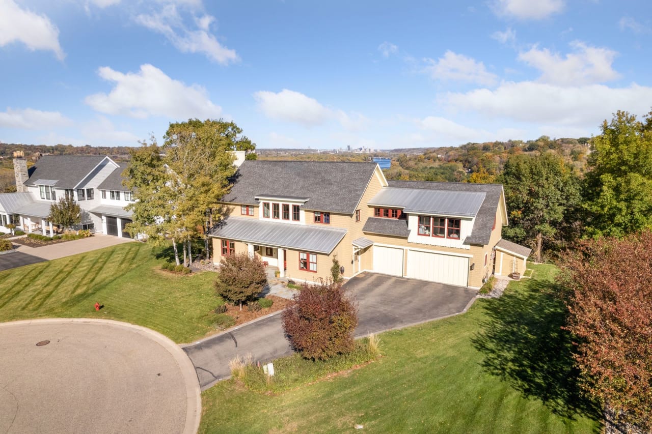 Panoramic view of a tranquil suburban neighborhood with neatly arranged homes and lush greenery.