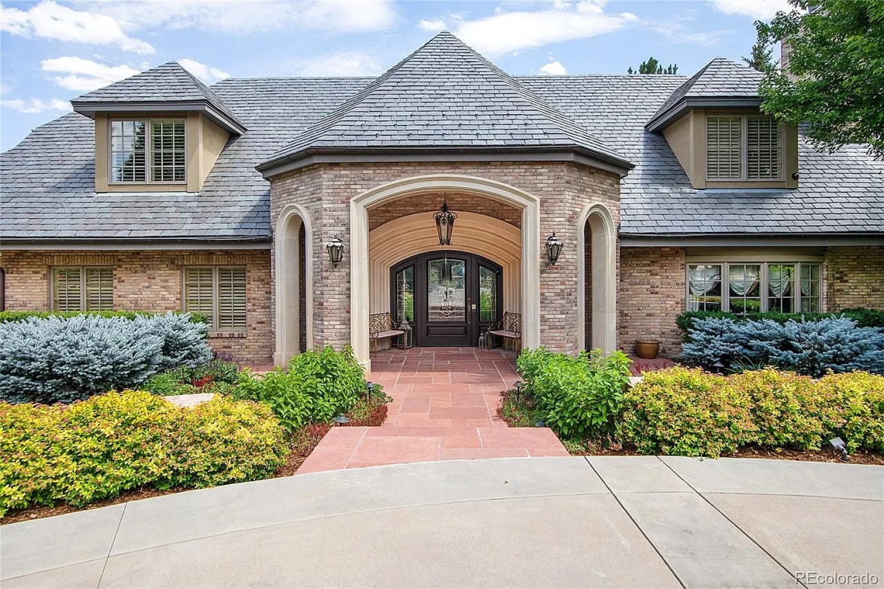 A sprawling Colorado mansion with a brick exterior and slate roof