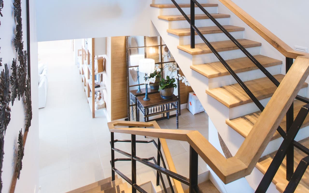 A staircase with wooden treads and a metal railing.