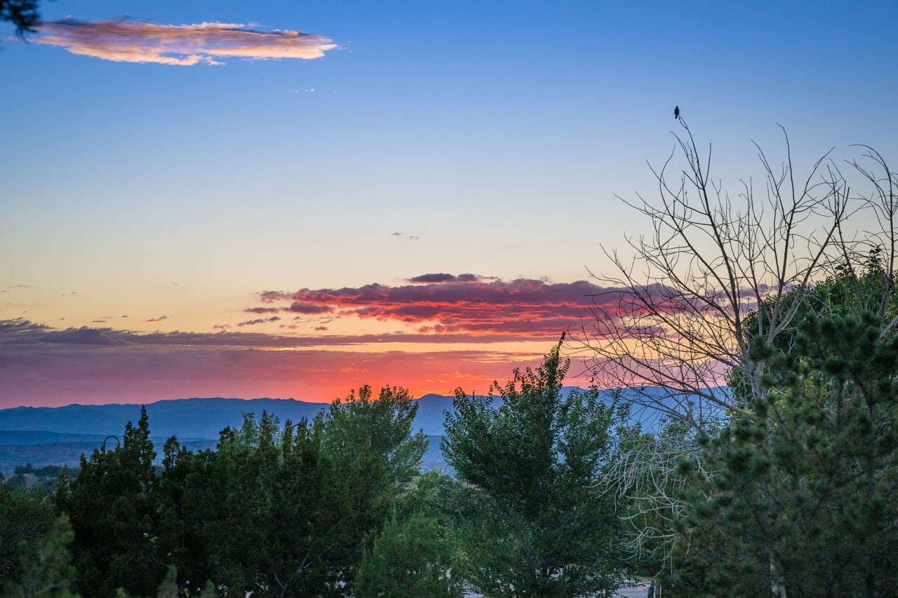 A scenic view of a sunset over a mountain range