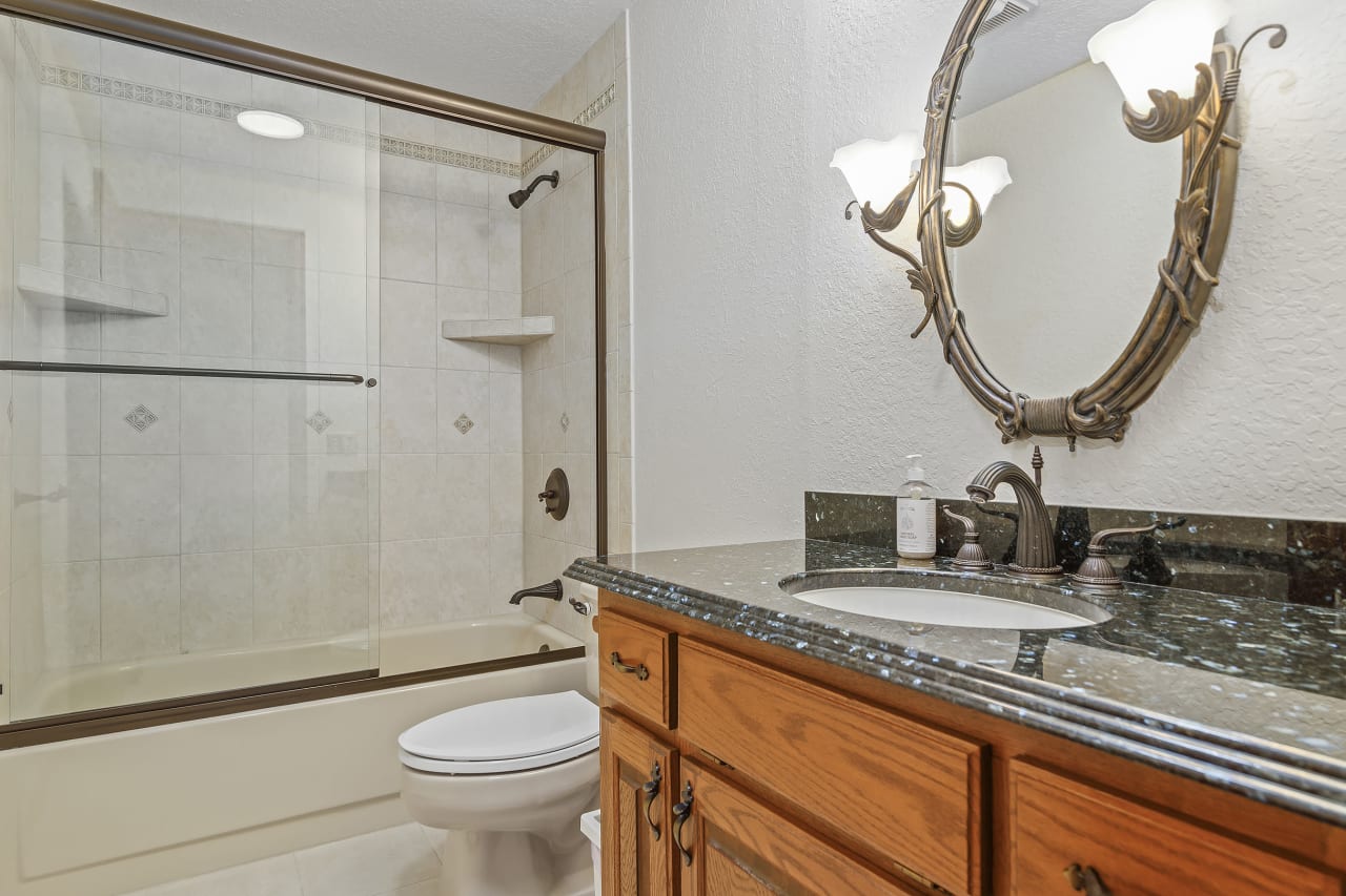 The bonus room features a convenient bath with a tiled tub, providing an added layer of comfort and style to this versatile space.