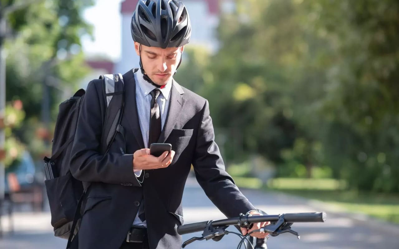 Portrait of a male commuter wearing bike helmet in a town. Safe cycling in city, bicycle co