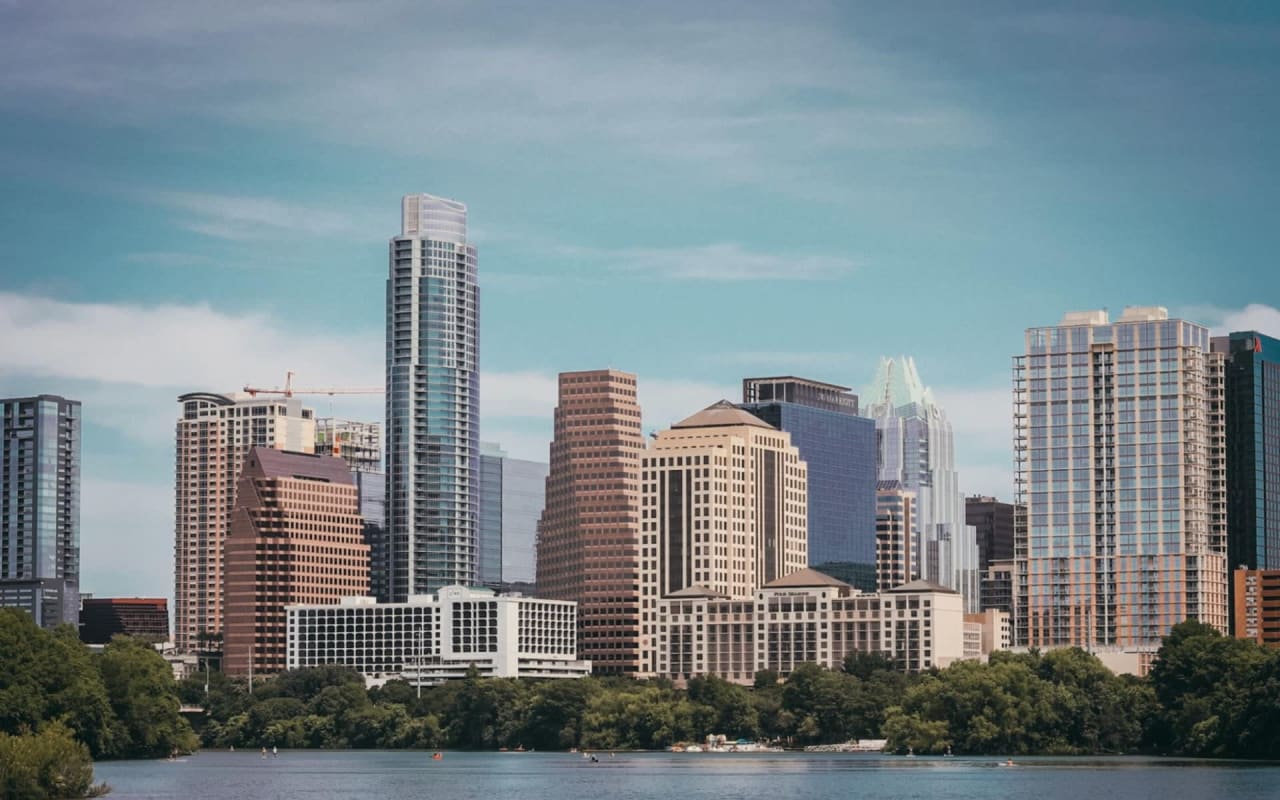 Made a wallpaper with the Houston skyline with Travis wearing his