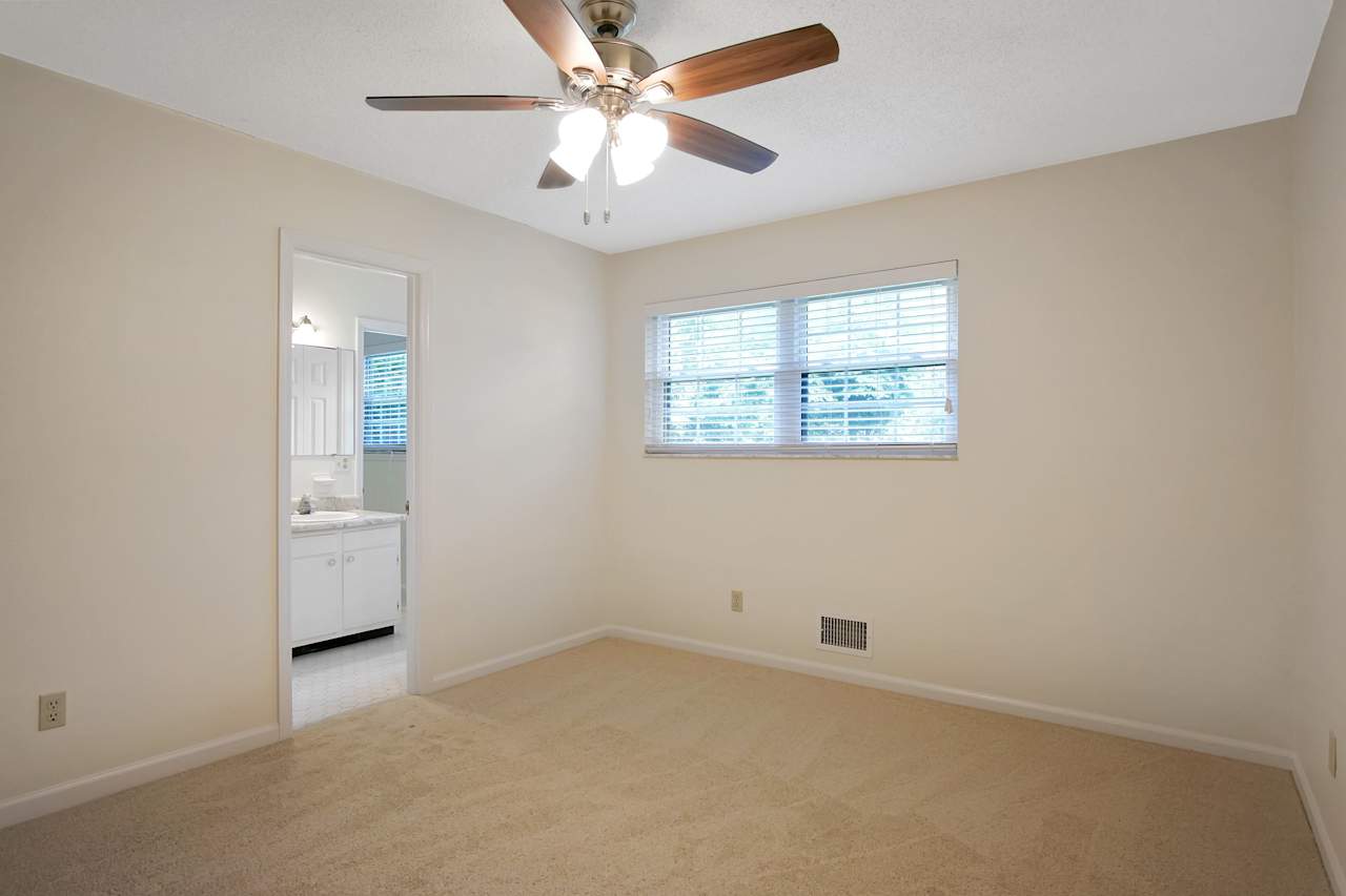 Photo of bedroom featuring lightly colored carpet, lightly colored walls