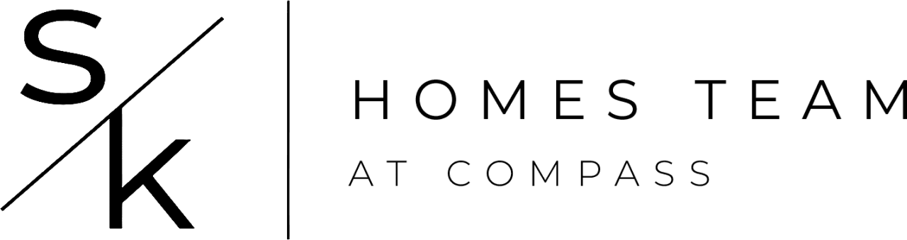 A dark logo of the real estate team The SK Homes Team at Compass.