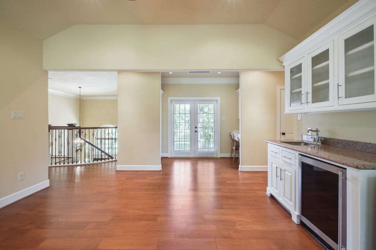 Small study space with built in bookshelves with double doors leading to Juliet balcony.