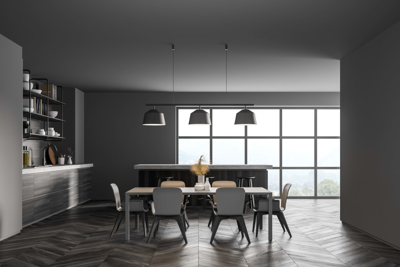 a rustic dining room with a long wooden table and an eclectic mix of chairs